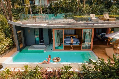 a house with a pool and two people in it at SYLVAN Koh Chang in Ko Chang