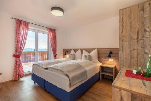 a bedroom with a large bed and a large window at Radstädter Hütte am Rossbrand in Radstadt
