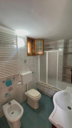 a bathroom with a toilet and a sink at B&B Dimora Muzio and Restaurant in Gallipoli