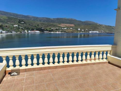 a balcony with a view of a body of water at Chic Magnificent Sea View Suite in Andros