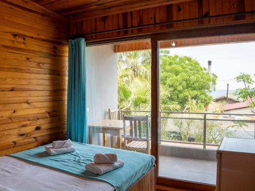 a bedroom with a bed and a large window at Atıcı 2 Hotel in Adrasan