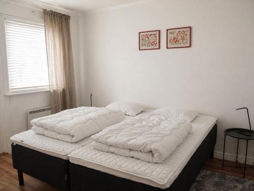 a bed with two pillows on it in a bedroom at Solbacka Apartment in Södra Ås