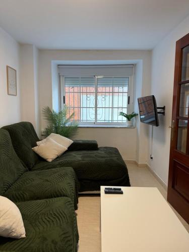 a living room with a couch and a table at Casa do medio in Corcubión