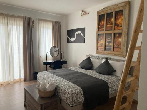 a bedroom with a bed and a wooden ladder at Mamma Adelina in Enna