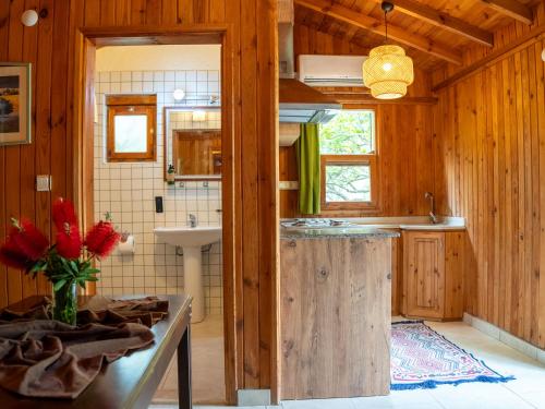 a kitchen with wooden walls and a sink and a counter at Atıcı 2 Hotel in Adrasan