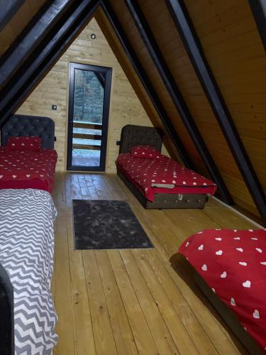 a room with two beds and pillows in a attic at ROMANIJA vikendice in Sarajevo