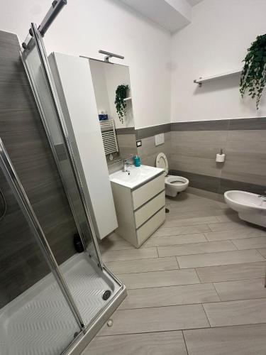 a bathroom with a shower and a sink and a toilet at Portunno Relax House in Fiumicino