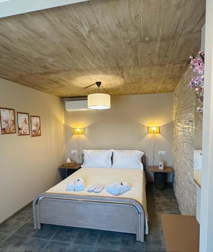 a bedroom with a bed with two towels on it at Hill House in Kavála