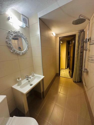 a bathroom with a sink and a mirror at Hill House in Kavála