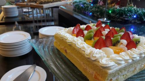 a cake with fruit on it sitting on a table at Hotel Santika Bogor in Bogor