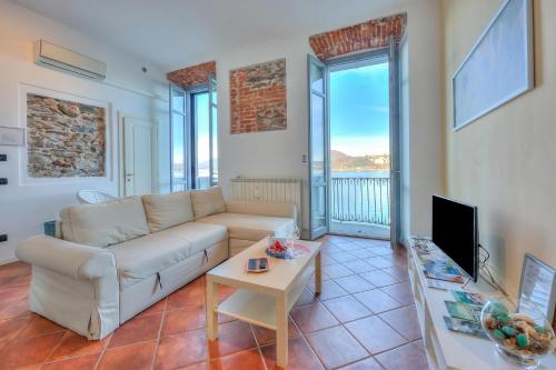 a living room with a couch and a table at Aparthotel Arona in Arona