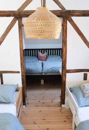 a room with two beds and a chandelier at Altes Winzerhaus Stegmann in Sankt Martin