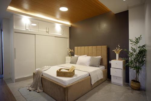 a bedroom with a large bed with a basket on it at Yanna's Unit - 3Bedroom with Breakfast in Baguio