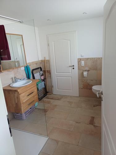 a bathroom with a sink and a toilet and a mirror at Ferienwohnung Landlust in Treuchtlingen