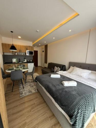 a bedroom with a large bed and a dining room at Misho Hills Retreat in Kopaonik