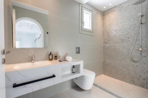 a bathroom with a sink and a shower at Eidolion Essence - Mykonos Villa with Private Pool in Ano Mera
