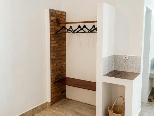 a room with a fireplace and a brick wall at Villa Agati in Siem Reap