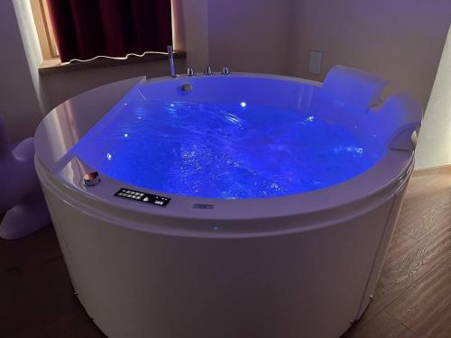 a large blue tub with a sink in a room at Lo Berio Morgex in Morgex