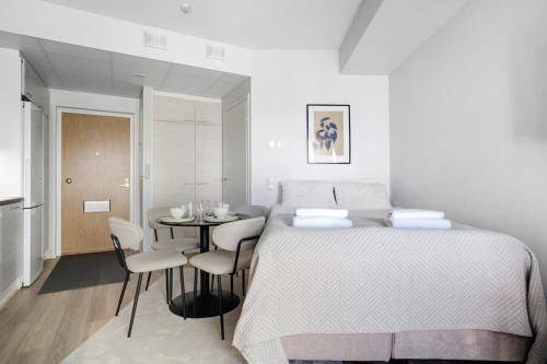 a bedroom with a bed and a table with chairs at Modern Arctic Studio By Lapland Host in Rovaniemi