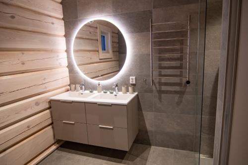 a bathroom with a sink and a mirror at Sommarbukt Tind - Luxury Fjord Lodge near Tromsø in Tromsø