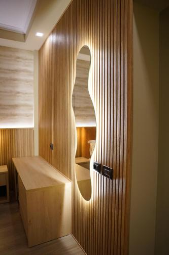 a wooden door in a room with a desk at Lumera Hotel in Durrës