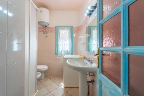 a bathroom with a sink and a toilet at Raffy by DomusAway in Porto San Paolo
