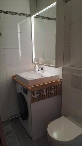 a small bathroom with a sink and a toilet at Saltwater Hohwacht in Hohwacht