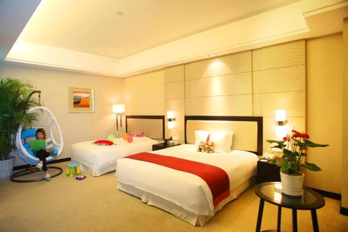 a hotel room with two beds and a child in a swing at Haiwahai Hotel - Thousand Island Lake in Thousand Island Lake