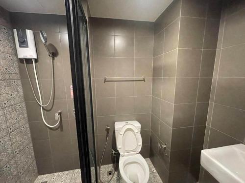 a bathroom with a toilet and a shower stall at Exclusive Condo with Pool - Self Check-in in Hua Hin