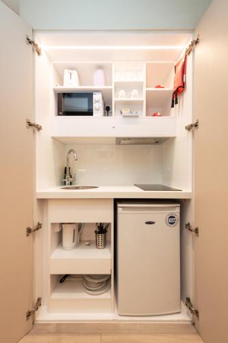 a small kitchen with a sink and a refrigerator at 39 Studios in London