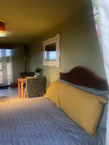 a bedroom with a bed and a table and a chair at Digital detox unplugged retreat in Southam