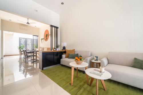 a living room with a couch and a table at Cove Amayana in Surabaya