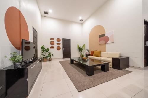 a living room with a couch and a coffee table at Cove Amayana in Surabaya