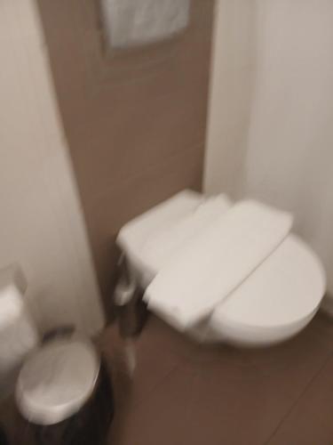 a small bathroom with a toilet and a stool at Πόλη της Κέρκυρας διαμέρισμα in Corfu