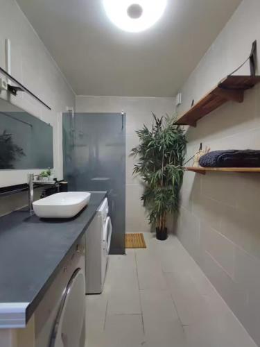a bathroom with a sink and a washing machine at Le Châlet Nature de Lieurey in Lieurey