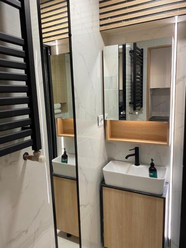a bathroom with a sink and a mirror at Natalia 2 in Mrągowo