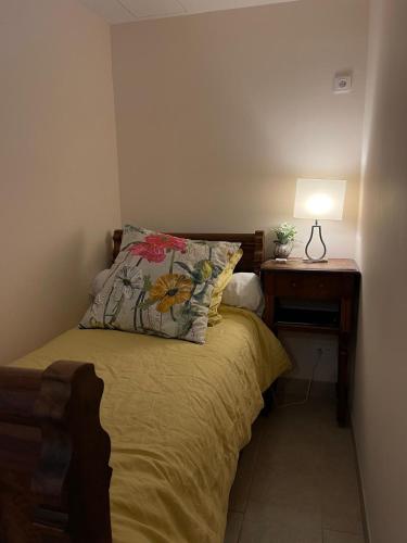 a bedroom with a bed and a nightstand with a lamp at La rosée in Montanay