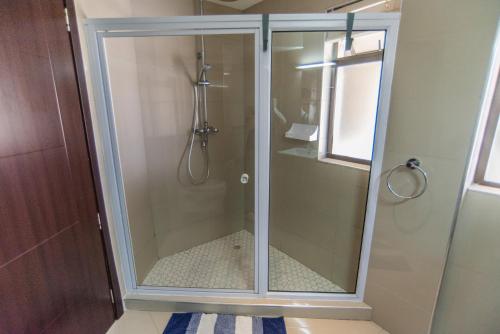a shower with a glass door in a bathroom at Beach View Apartment 205 in Swakopmund