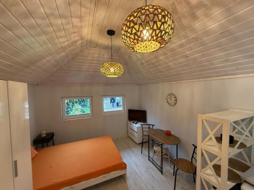 a room with a bed and a desk and two lights at Mini Apart - Gdańsk Jelitkowo in Gdańsk