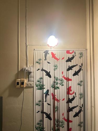 a shower curtain with fish on it in a bathroom at The Station Hostel in Sathani Ayutthaya