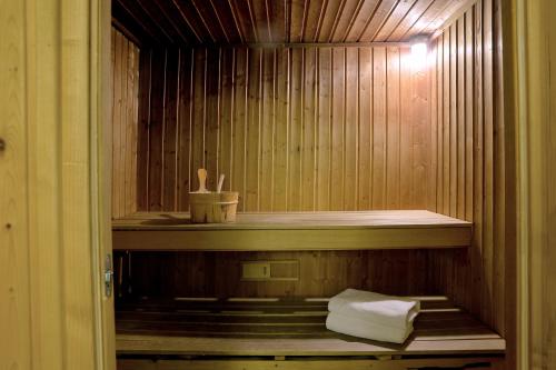 a sauna with a shelf and towels in it at Airotel Stratos Vassilikos Hotel in Athens