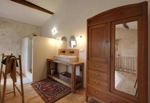 a kitchen with a sink and a wooden cabinet at Small country house with authentic charm in Baurech