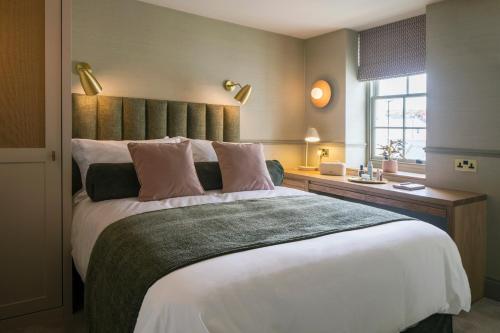a bedroom with a large bed and a window at Sigma Plus Regency Square Suites near Brighton Beach in Brighton & Hove