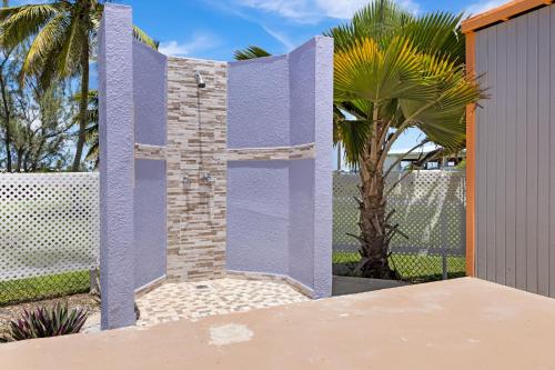 a purple fence with a gate and a palm tree at Caribbean View for You condo in Christiansted