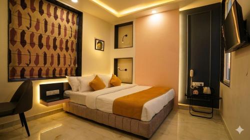 a bedroom with a bed and a television in it at Hotel The Hidden Door-Near Jaipur Airport in Jaipur