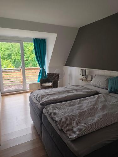 a bedroom with a bed and a large window at Schlei-Liesels Ferienwohnungen in Güby