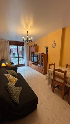 a living room with a couch and a table at piso en la playa in Noja