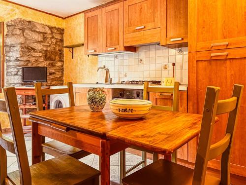 a kitchen with a wooden table with a bowl on it at Casa al Sasso - Appartamenti immersi nella natura in Lizzano in Belvedere