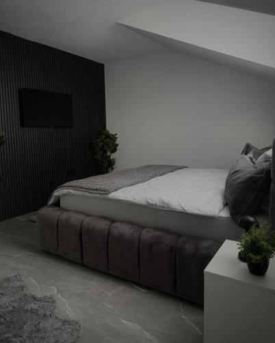 a bedroom with a bed with a large ottoman sidx sidx sidx at AD PRESTIGE Apartment in Gradačac
