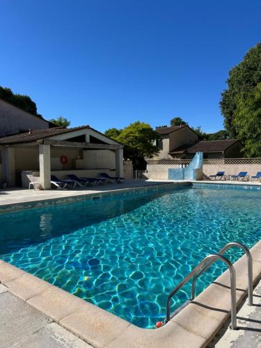 a swimming pool with blue water at La maison papillons in Quissac